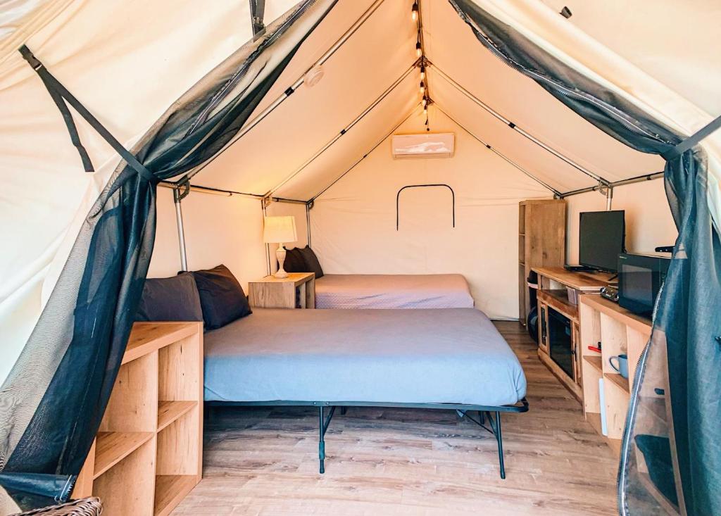 a bedroom with two beds in a tent at Son's Rio Cibolo - Glamping Cabin #J Romantic Getaway on Gorgeous Cibolo Creek! in Marion