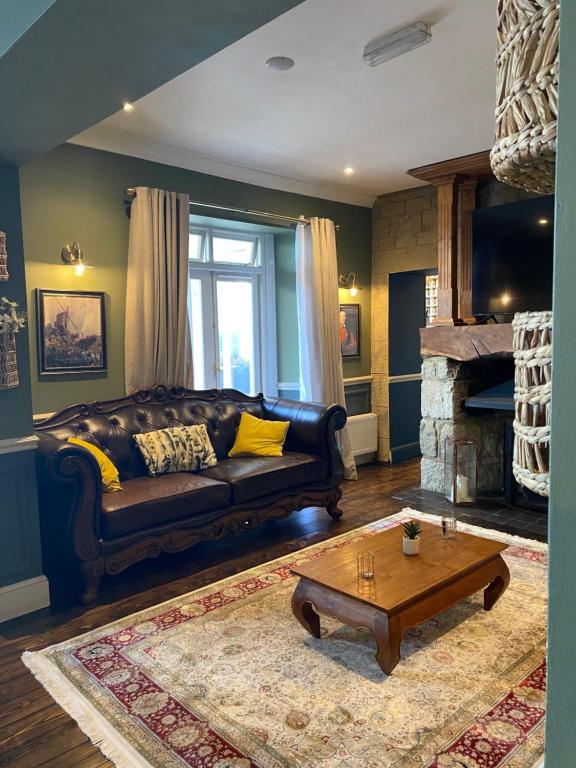 a living room with a couch and a coffee table at The Wellington Hotel in Ventnor