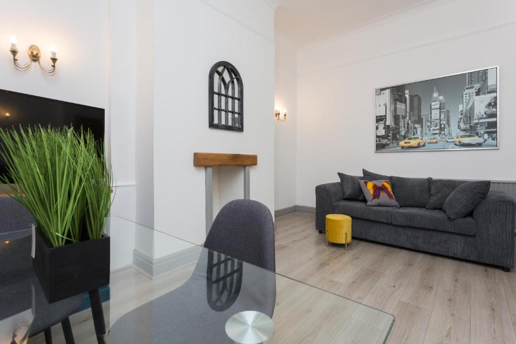 a living room with a glass table and a couch at The Station House in Preston