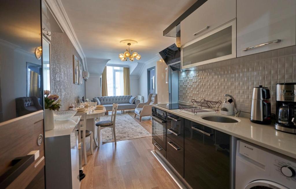 a kitchen with a sink and a living room at Fully Equiped Apartment In Istanbul Avcilar - Zarif-60 in Avcılar