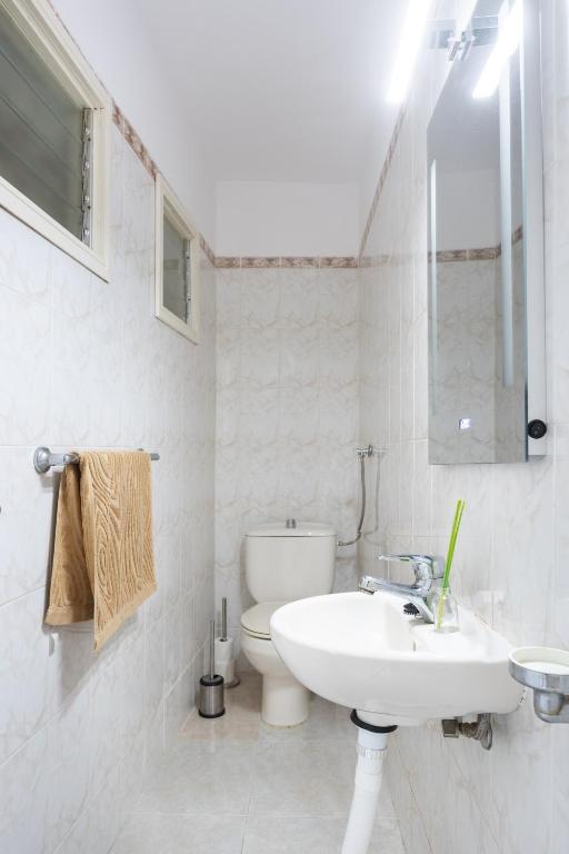 a white bathroom with a sink and a toilet at Home2Book Charming Duplex Tabaiba in Tabaiba
