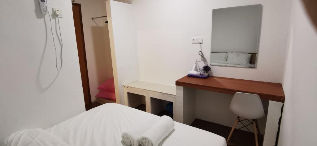 Postel nebo postele na pokoji v ubytování Tang Hotel