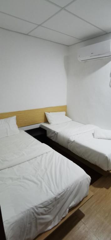 Postel nebo postele na pokoji v ubytování Tang Hotel
