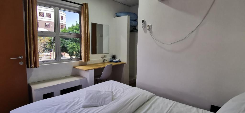 Postel nebo postele na pokoji v ubytování Tang Hotel