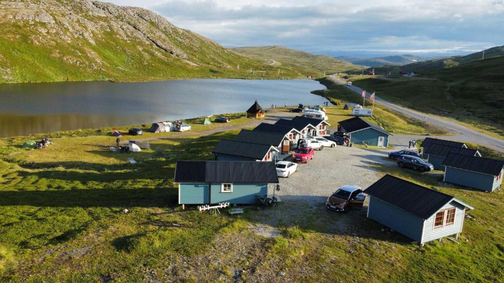 an aerial view of a group of huts next to a lake at Hytte Camp Nordkapp - Blue in Skarsvåg