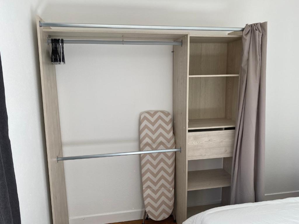 a walk in closet with ajar door and a bed at Appartement Le Lauzet in La Roche-de-Rame