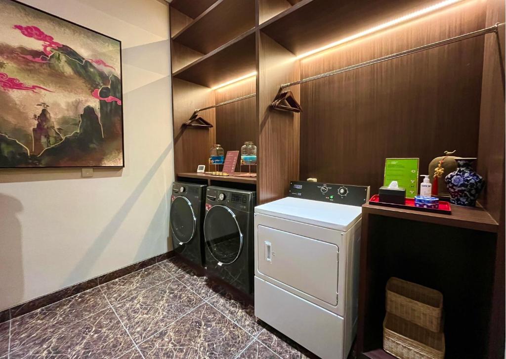 a laundry room with a washer and dryer at Ashley Tang Menteng Jakarta in Jakarta