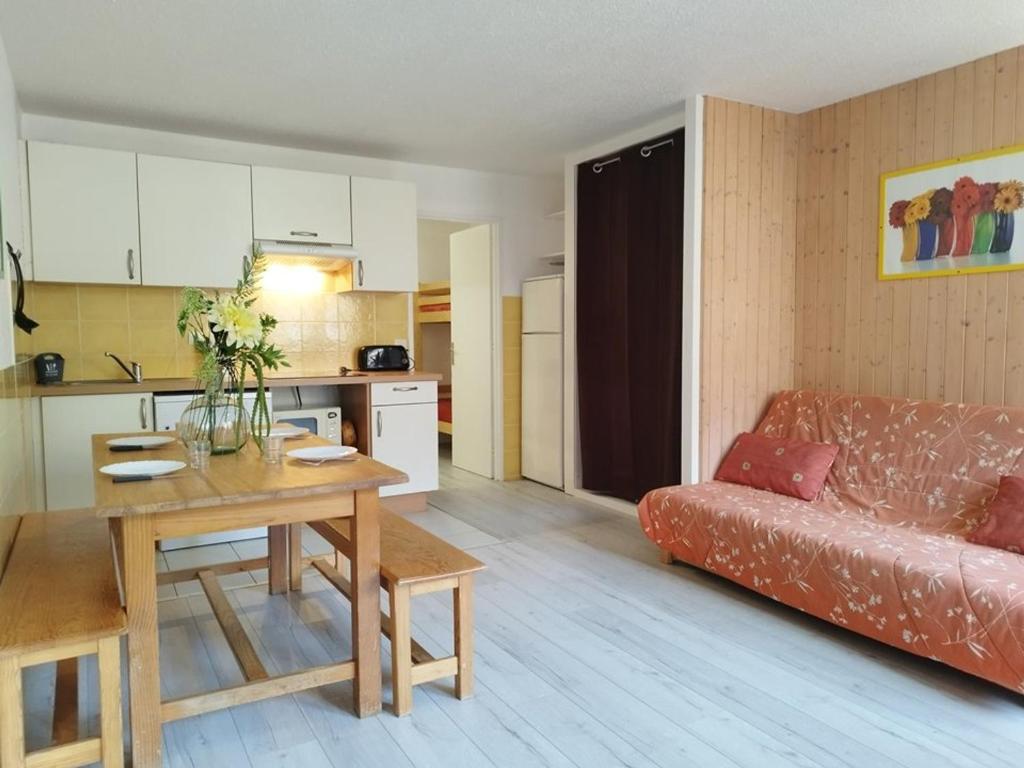 a living room with a table and a couch at Appartement Orcières Merlette, 2 pièces, 8 personnes - FR-1-262-137 in Forest des Baniols