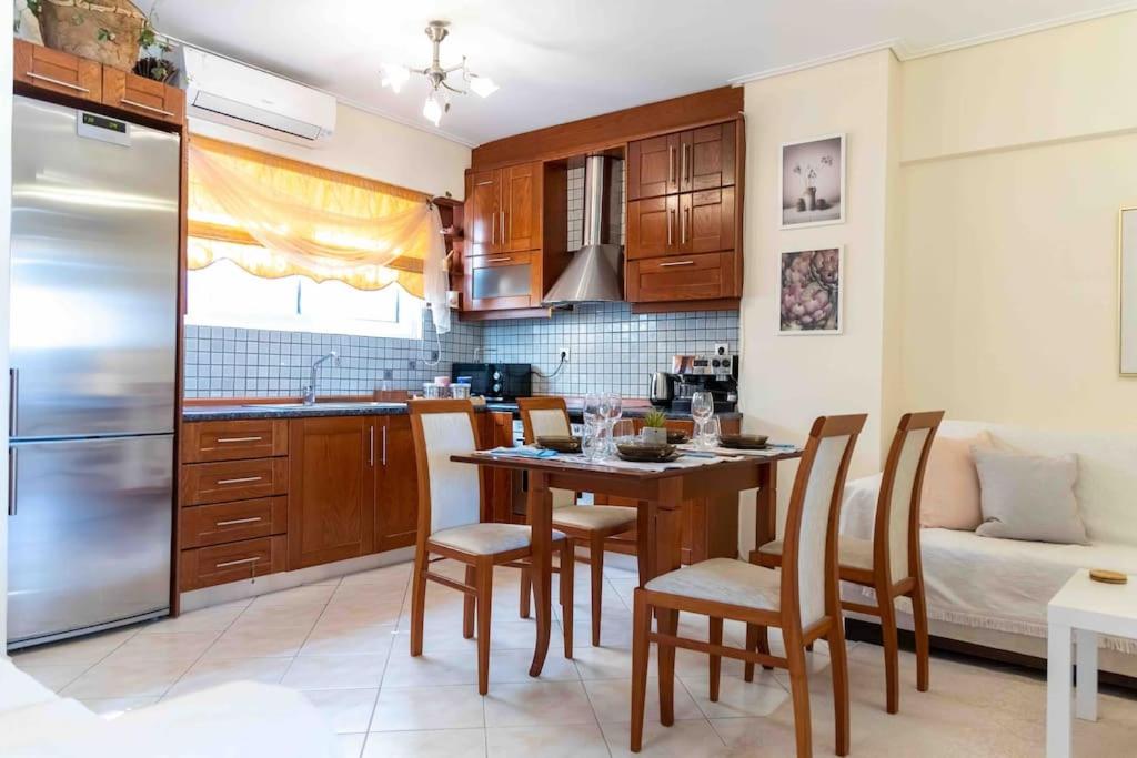 a kitchen with a table and chairs in a room at Peristeri 2 BD flat next to metro Agios Antonios in Athens