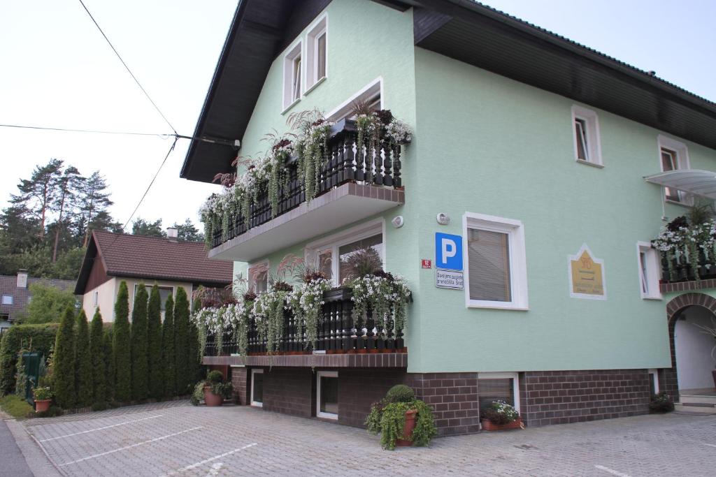 a building with flowers on the balconies of it at Homestay Sreš in Mlaka pri Kranju