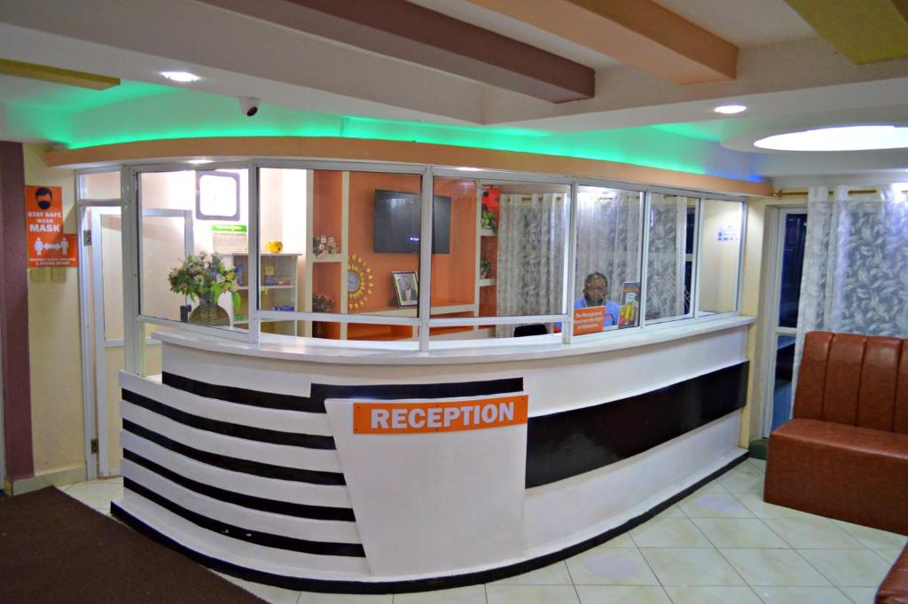 a reception desk in a hospital lobby with green lights at Montana Guest Resort Naivasha in Naivasha