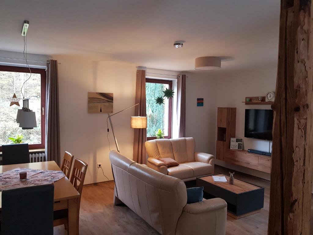 a living room with a couch and a chair and a table at Ferienwohnung Schützenhaus in Bad Ems