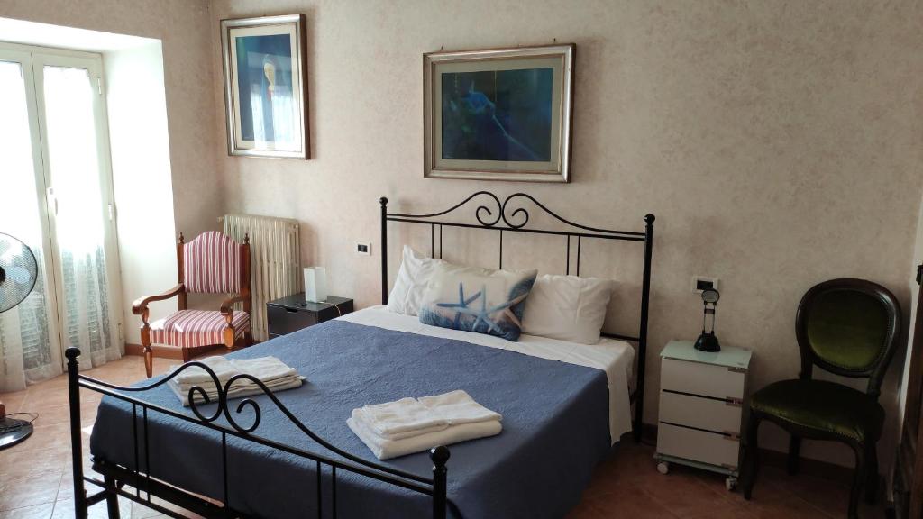 a bedroom with a bed with a blue comforter at Allacattedrale in Sora