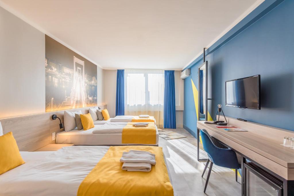Postel nebo postele na pokoji v ubytování Impulso Fashion Hotel