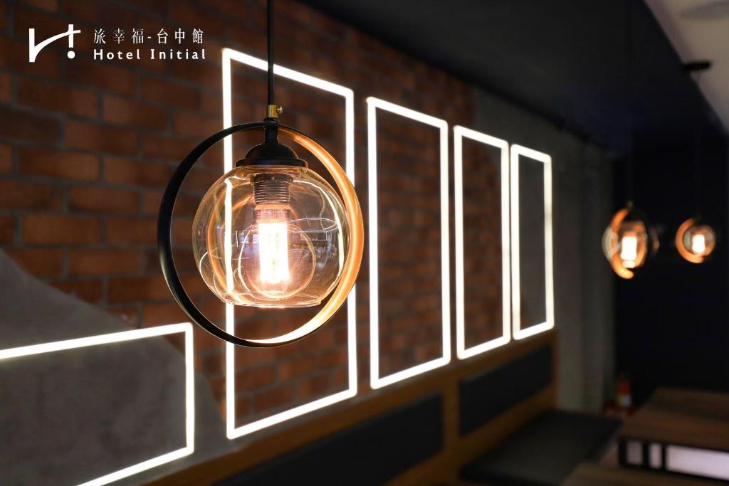 a light fixture hanging from a brick wall at Hotel Initial-Taichung in Taichung
