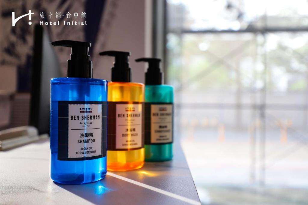 three bottles of hair products sitting on a counter at Hotel Initial-Taichung in Taichung