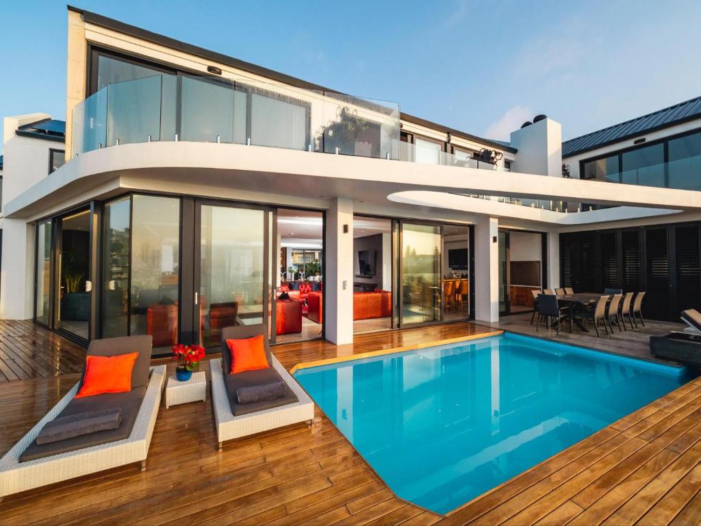 a house with a swimming pool in front of it at Boutique Ocean Views - incorporating Wendy's in Hermanus