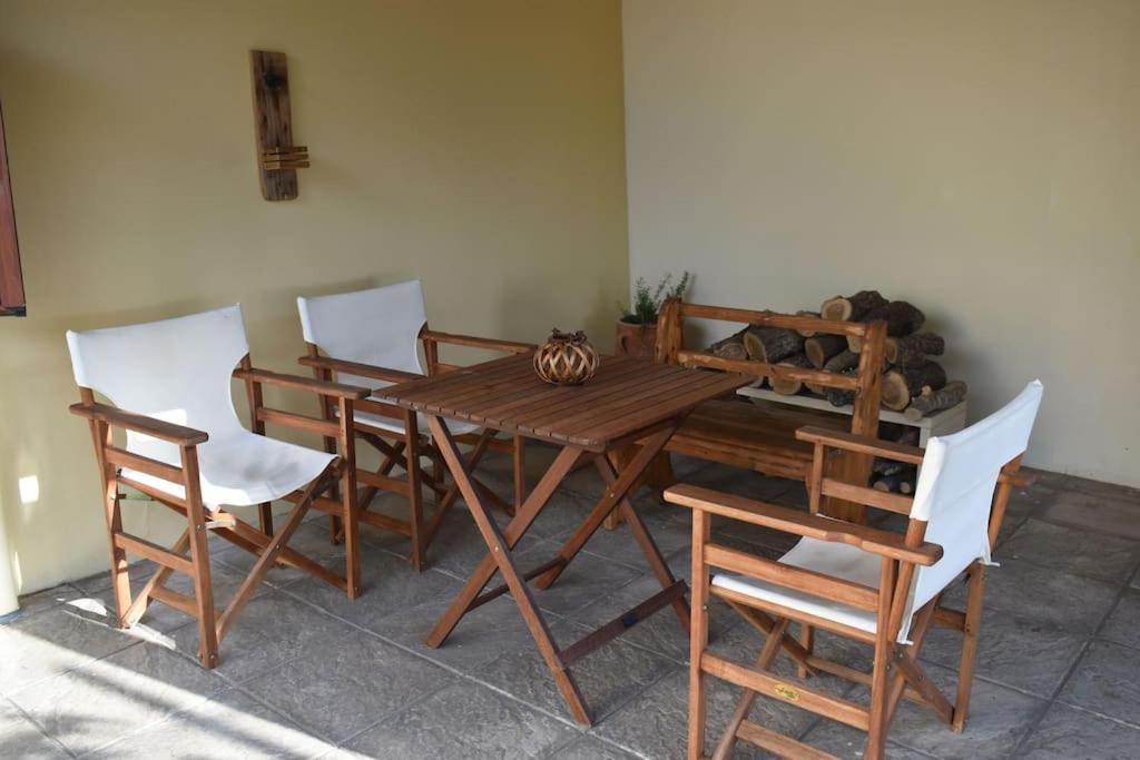 a wooden table and chairs in a room at Lithos House in Monólithos