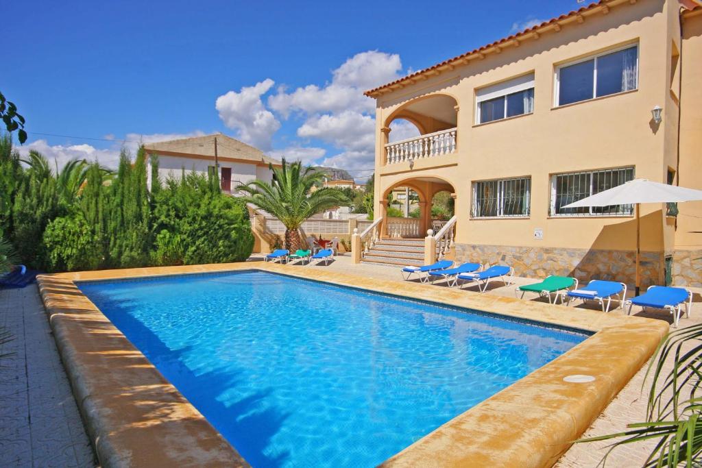 a swimming pool in front of a house at Villa Senieta - PlusHolidays in Calpe
