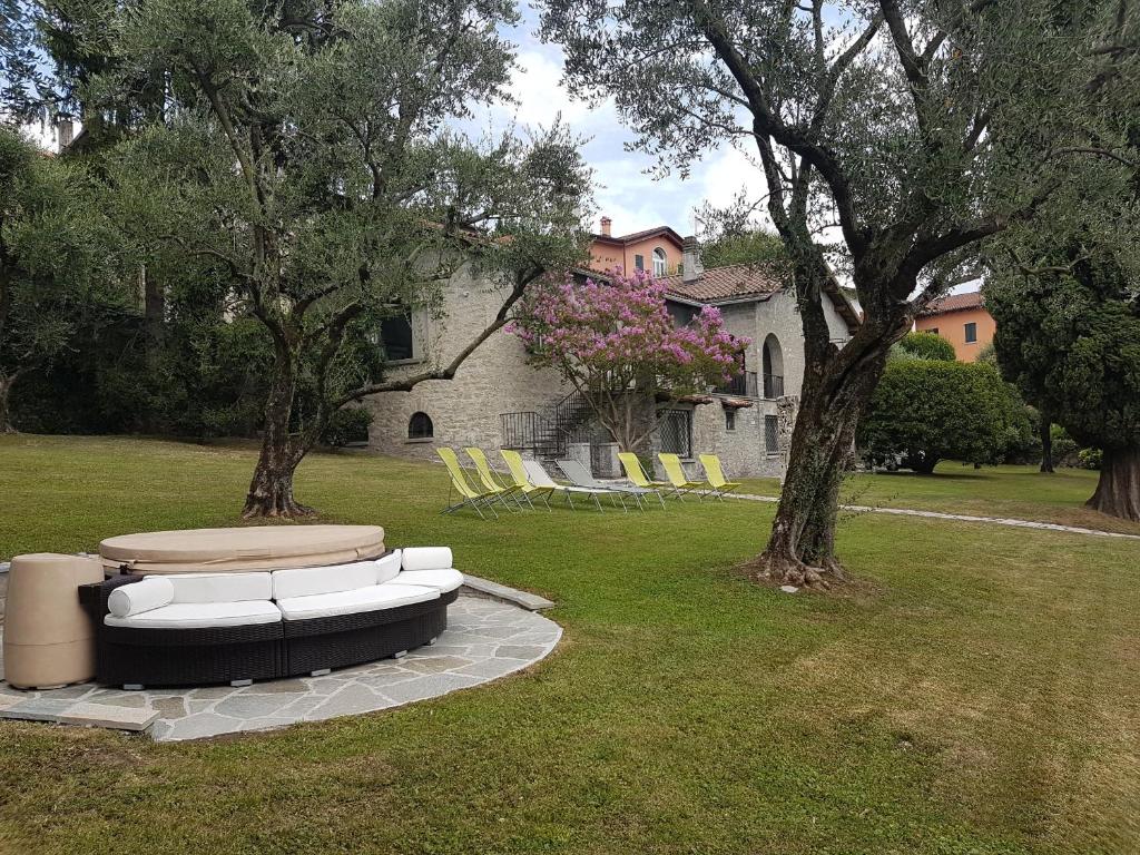 a group of chairs sitting in the grass in a yard at Villa delle Fiabe - Homelike Villas in Ossuccio