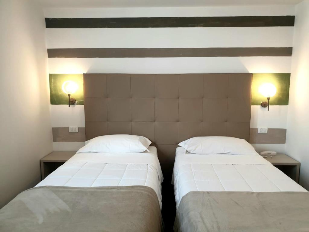 Postel nebo postele na pokoji v ubytování Hotel Grel