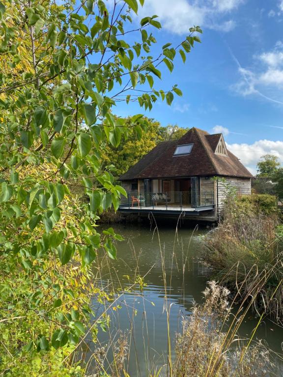 a house on the water with a river at Weavers Rest in Biddenden