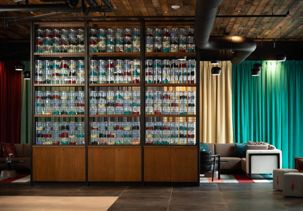 a room with a large wall of soda bottles at Hotel Indigo - Madison Downtown, an IHG Hotel in Madison
