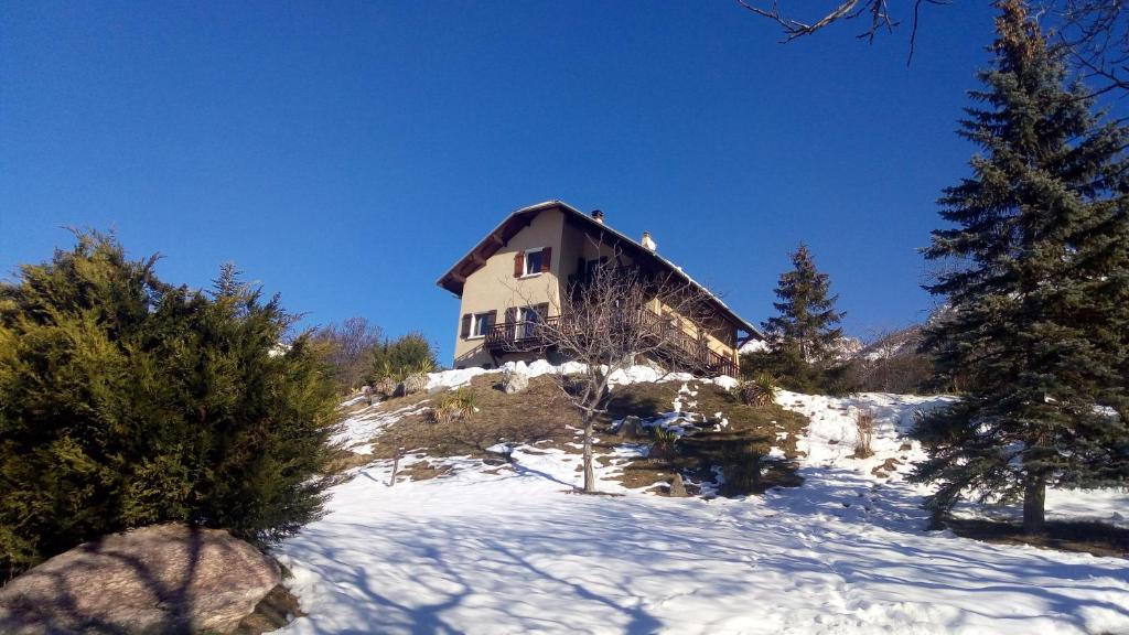 a house on top of a snow covered hill at Amazing view in Eygliers