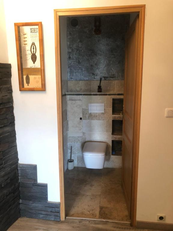 a bathroom with a toilet through a doorway at Amazing view in Eygliers