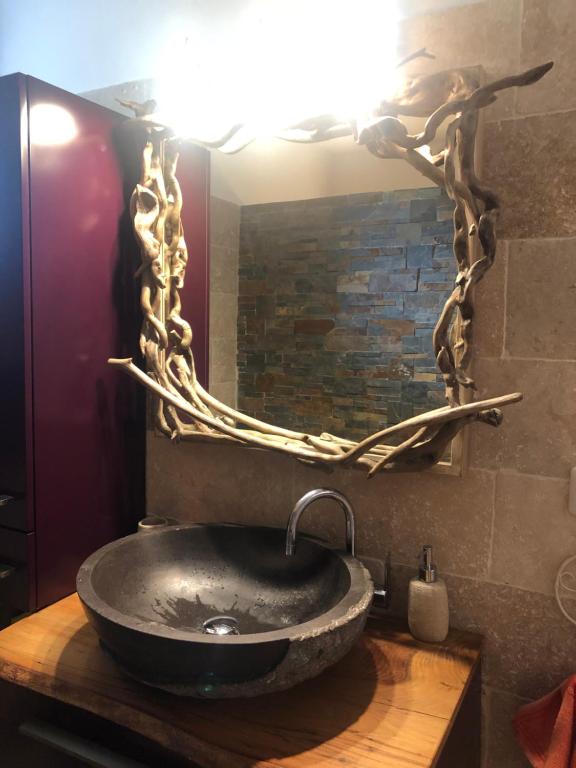 a bathroom with a sink with a large mirror at Amazing view in Eygliers