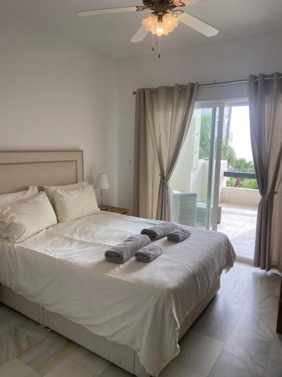 a bedroom with a bed with two towels on it at ARRUZAFA PLAYA Beachfront apartment La Cala de Mijas in La Cala de Mijas