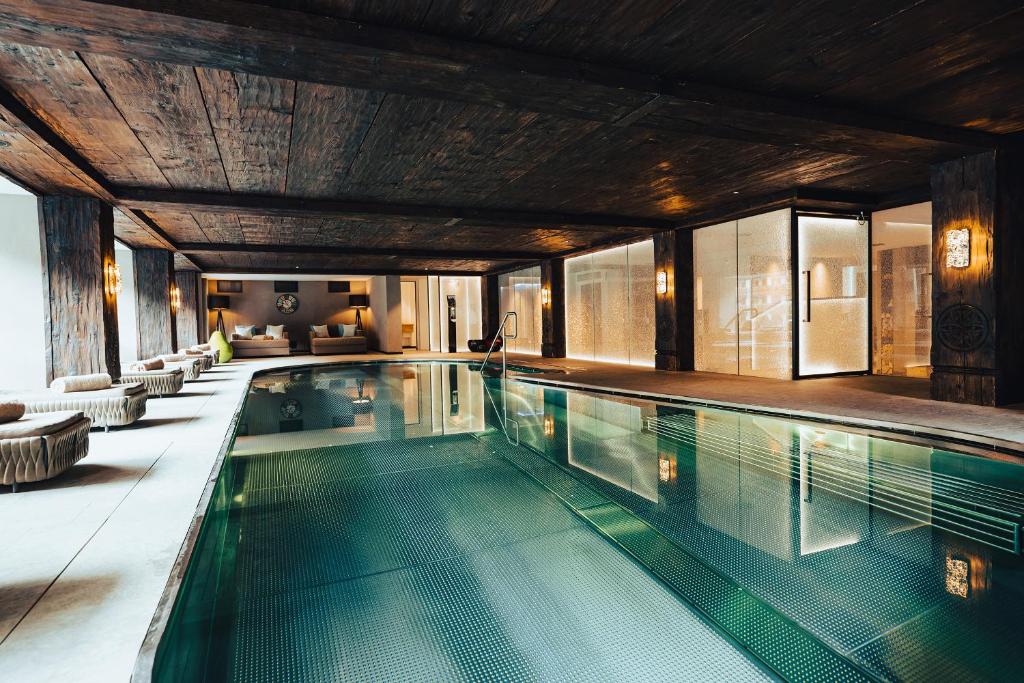 an indoor swimming pool in a house at Wellness Hotel Alpenhof in Zermatt