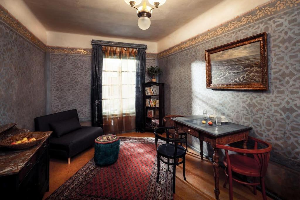 a living room with a table and chairs and a couch at Apartmány Za branou in Kutná Hora