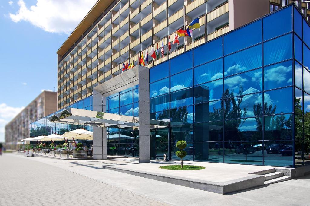 a large glass building with a large window at Intourist Hotel in Zaporozhye