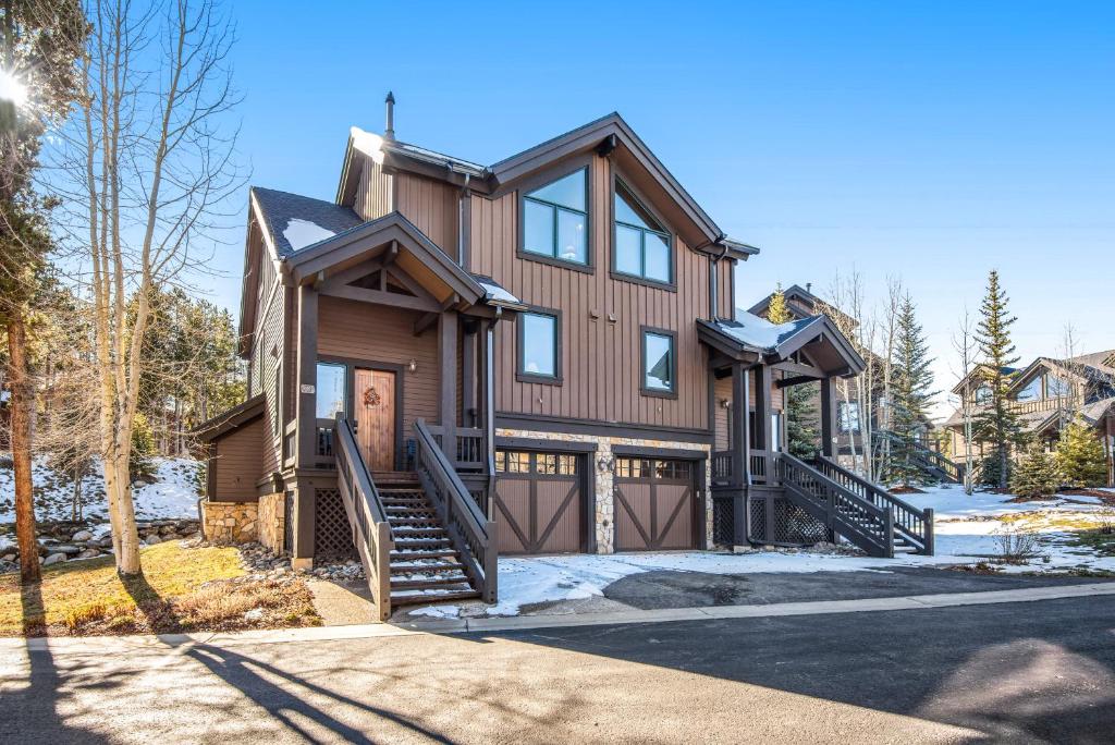 a home with a wooden house with a garage at Saddlewood in Breckenridge
