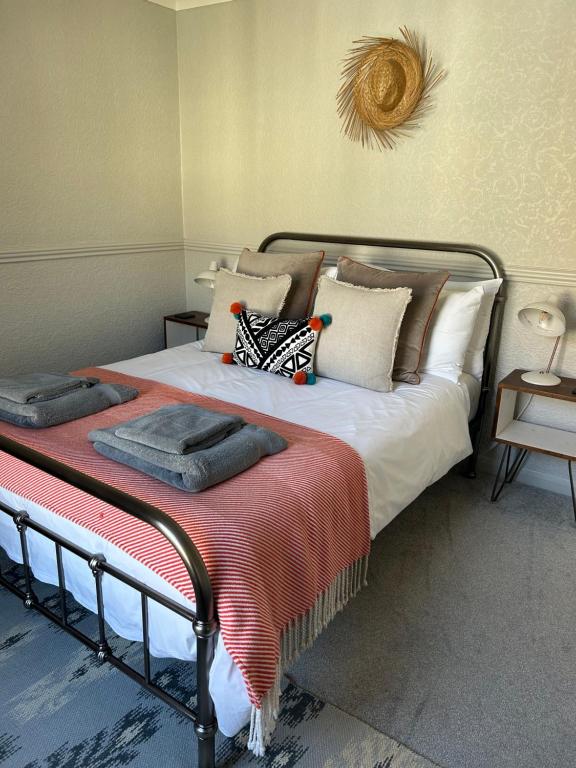 a bedroom with a bed with pillows on it at Sea Song Cottage in Broadstairs