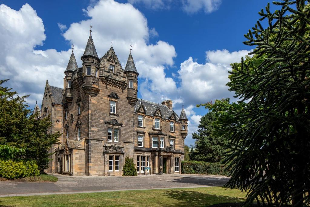 an old castle with turrets on a sunny day at The Scott in Edinburgh