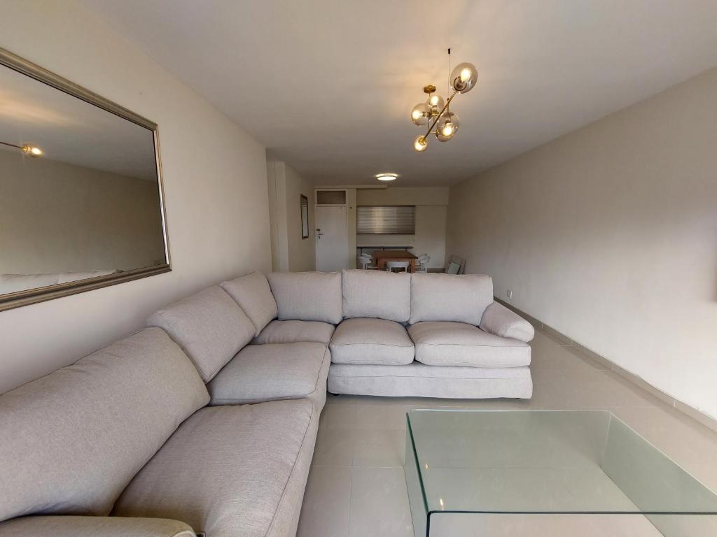 a living room with a couch and a table at Umhlanga Beach 3 Bedroom Apartment in Durban