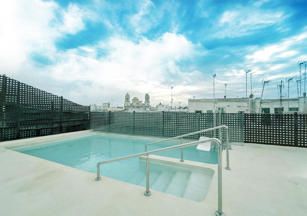 a swimming pool on the roof of a building at ISA Cádiz in Cádiz