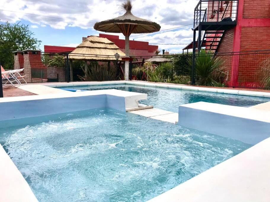 a large swimming pool with a large swimming pool at CABAÑA LA MILAGROS REINA MORA in Merlo