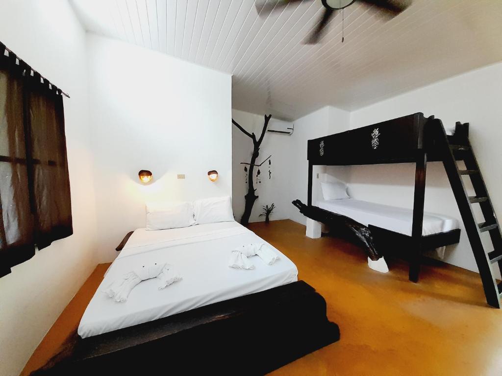 a bedroom with a black bed and a ladder at Hibiscus Garden in Santa Catalina