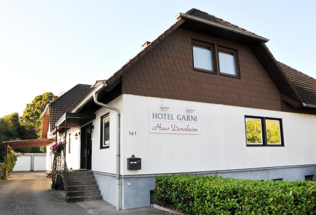 a building with a sign on the side of it at Hotel Garni Haus Dornheim in Obertshausen