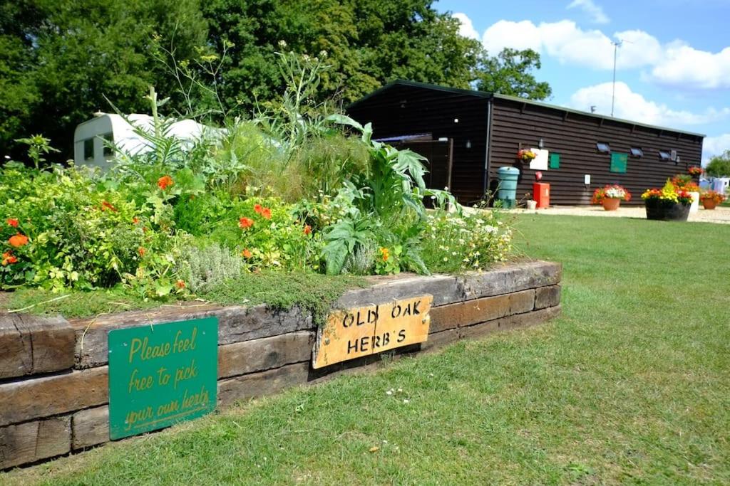 a garden with a sign that reads only only herbs at Glamping at South Lytchett Manor in Poole