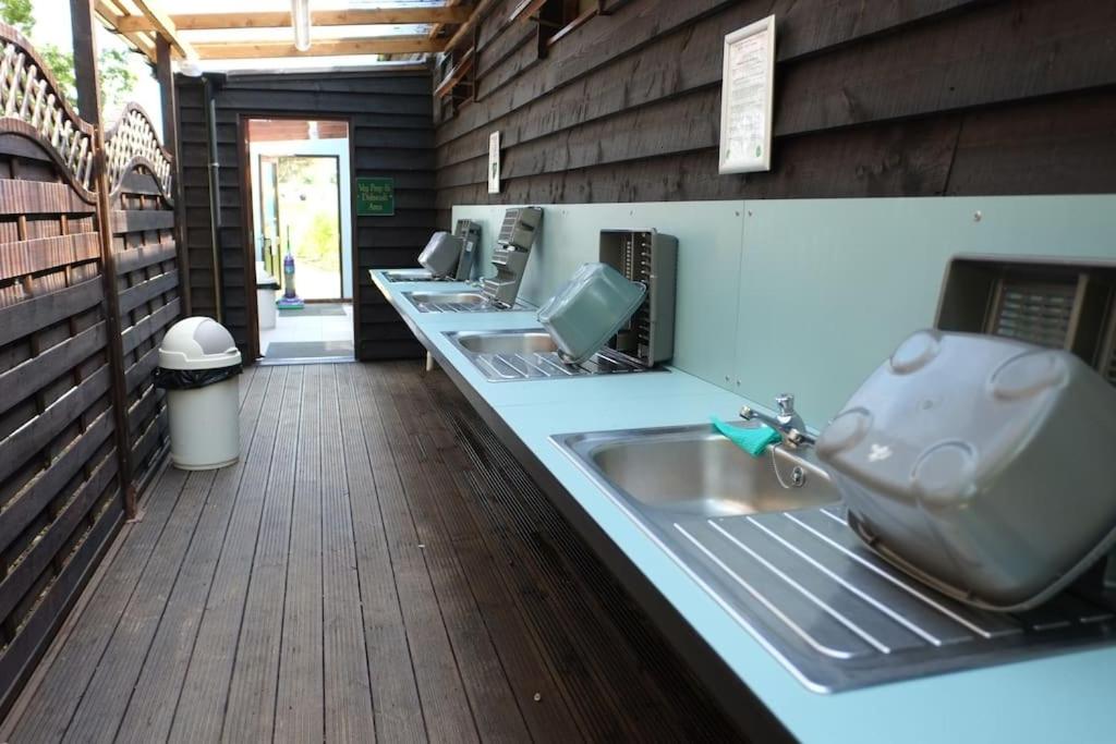 a row of sinks in a public restroom at Glamping at South Lytchett Manor in Poole