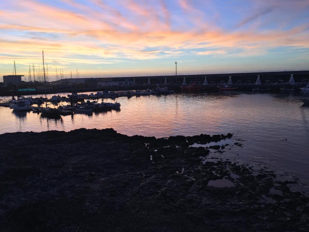 a marina with boats in the water at sunset at Apto Tagoro, La Restinga in La Restinga