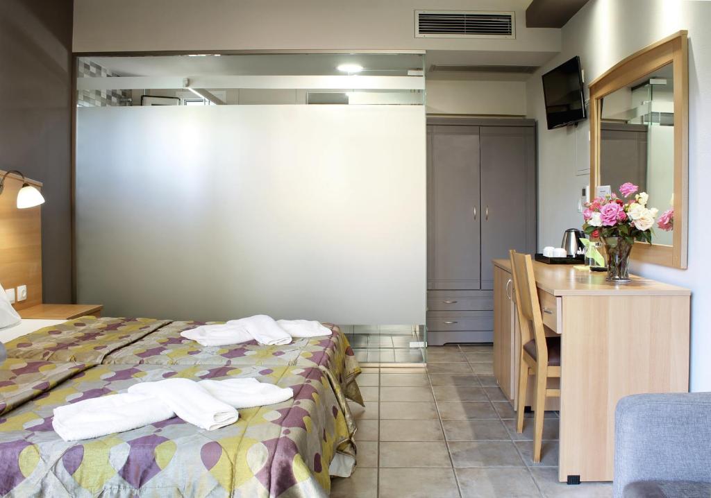 Postel nebo postele na pokoji v ubytování Paspalis Hotel