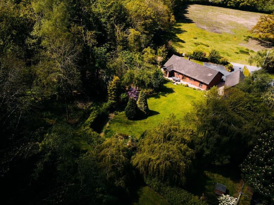 an aerial view of a house in a field at Country Crabtree Bungalow with large wild garden 