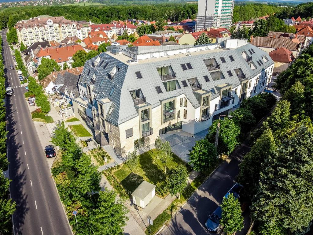 an overhead view of a large white building on a street at Sunshine Residence Deluxe Apartment in Hévíz