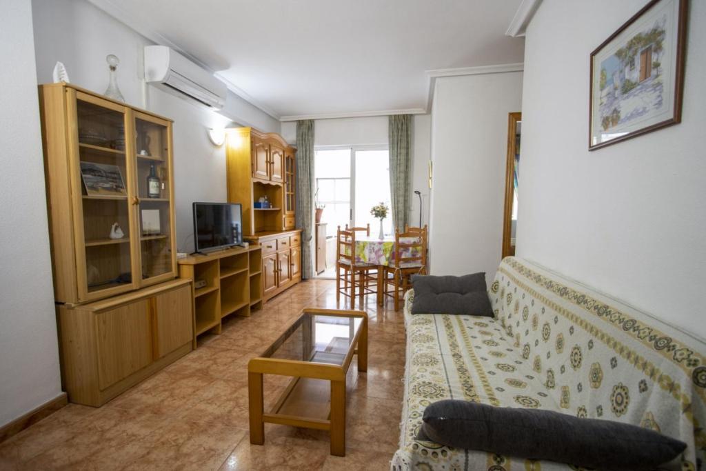 a living room with a couch and a table at Alegria ID40 in Torrevieja