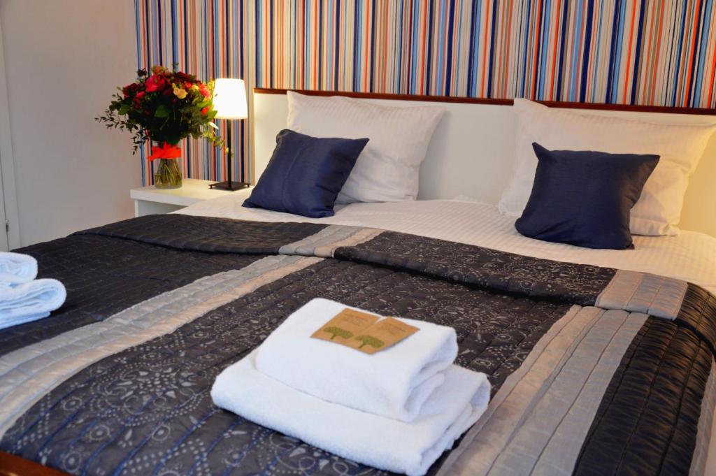 a bedroom with a bed with towels on it at Cracow Central Aparthotel in Krakow